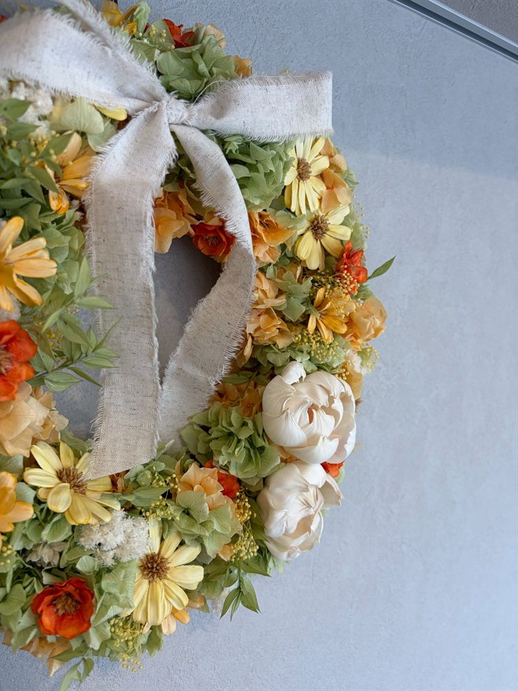 ドライフラワーリース 環 ― 黄と橙の花を編んだリースに麻のリボン